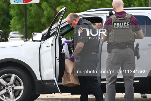 An FBI agent and a Chicago police officer are recovering the money at the scene on W. Belmont Ave. inside a vehicle that was used in the ban...