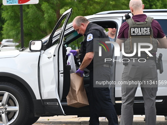 An FBI agent and a Chicago police officer are recovering the money at the scene on W. Belmont Ave. inside a vehicle that was used in the ban...