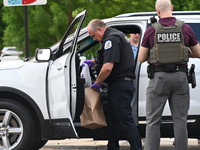 An FBI agent and a Chicago police officer are recovering the money at the scene on W. Belmont Ave. inside a vehicle that was used in the ban...