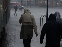 People are struggling to walk during the stormy weather in Dortmund, Germany, on June 18, 2024. (