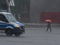 A woman is struggling with her umbrella during the storm in Dortmund, Germany, on June 18, 2024. (