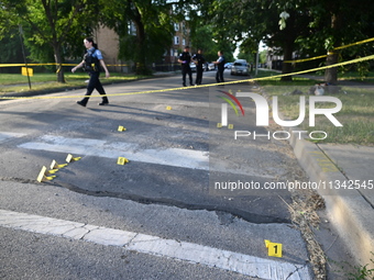 Shell casings are being located at the crime scene on Tuesday afternoon. Two men are in serious condition after being shot in Chicago, Illin...