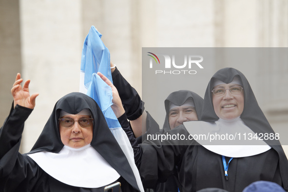 Nuns are waving an Argentinian flag during Pope Francis's weekly general audience in The Vatican, on June 19, 2024, at St Peter's Square. 