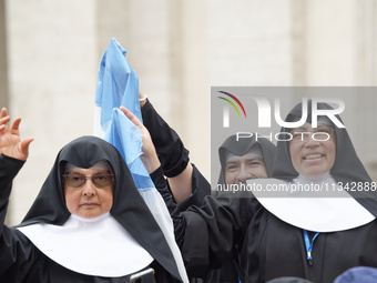 Nuns are waving an Argentinian flag during Pope Francis's weekly general audience in The Vatican, on June 19, 2024, at St Peter's Square. (