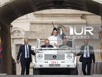 Pope Francis is waving as he is arriving to lead the weekly general audience in Saint Peter's Square, Vatican City, on June 19, 2024. (