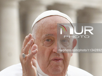 Pope Francis is blessing the crowd as he is arriving to lead the weekly general audience in The Vatican, on June 19, 2024, at St Peter's Squ...