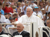 Pope Francis is waving as he is arriving to lead the weekly general audience in Saint Peter's Square, Vatican City, on June 19, 2024. (