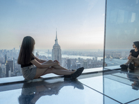 A woman is looking at the Empire State Building from the Summit One Vanderbilt observation deck in New York, U.S., on June 18, 2024. The att...