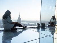 A woman is looking at the Empire State Building from the Summit One Vanderbilt observation deck in New York, U.S., on June 18, 2024. The att...