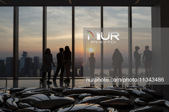 People are enjoying the sunset from the Summit One Vanderbilt observation deck in New York, U.S., on June 18, 2024. The Summit One Vanderbil...