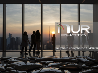 People are enjoying the sunset from the Summit One Vanderbilt observation deck in New York, U.S., on June 18, 2024. The Summit One Vanderbil...