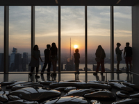 People are enjoying the sunset from the Summit One Vanderbilt observation deck in New York, U.S., on June 18, 2024. The Summit One Vanderbil...