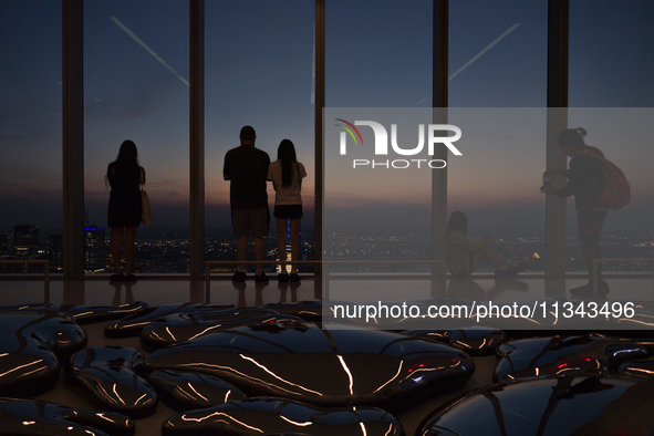 People are enjoying the sunset from the Summit One Vanderbilt observation deck in New York, U.S., on June 18, 2024. The Summit One Vanderbil...