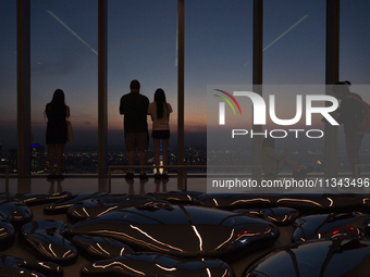 People are enjoying the sunset from the Summit One Vanderbilt observation deck in New York, U.S., on June 18, 2024. The Summit One Vanderbil...