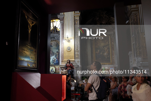 People are taking pictures of ''Dali's Christ'' at San Marcello al Corso Church in Rome, Italy, on June 19, 2024. Salvador Dali's famous pai...