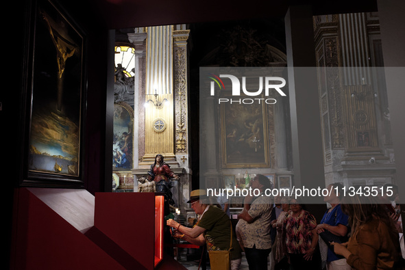 People are taking pictures of ''Dali's Christ'' at San Marcello al Corso Church in Rome, Italy, on June 19, 2024. Salvador Dali's famous pai...