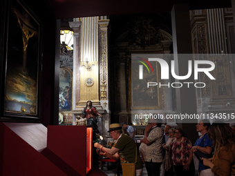 People are taking pictures of ''Dali's Christ'' at San Marcello al Corso Church in Rome, Italy, on June 19, 2024. Salvador Dali's famous pai...