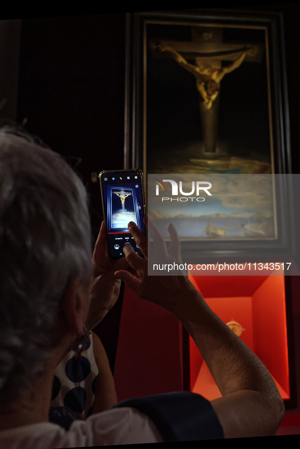 People are taking pictures of ''Dali's Christ'' at San Marcello al Corso Church in Rome, Italy, on June 19, 2024. Salvador Dali's famous pai...