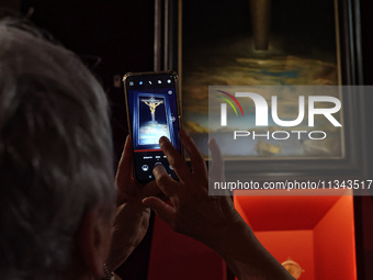 People are taking pictures of ''Dali's Christ'' at San Marcello al Corso Church in Rome, Italy, on June 19, 2024. Salvador Dali's famous pai...