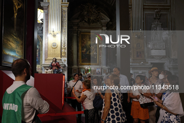 People are taking pictures of ''Dali's Christ'' at San Marcello al Corso Church in Rome, Italy, on June 19, 2024. Salvador Dali's famous pai...