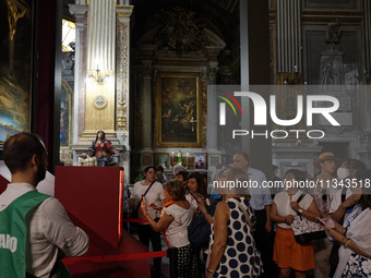 People are taking pictures of ''Dali's Christ'' at San Marcello al Corso Church in Rome, Italy, on June 19, 2024. Salvador Dali's famous pai...