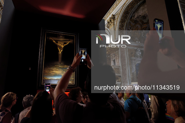 People are taking pictures of ''Dali's Christ'' at San Marcello al Corso Church in Rome, Italy, on June 19, 2024. Salvador Dali's famous pai...