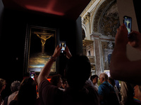 People are taking pictures of ''Dali's Christ'' at San Marcello al Corso Church in Rome, Italy, on June 19, 2024. Salvador Dali's famous pai...