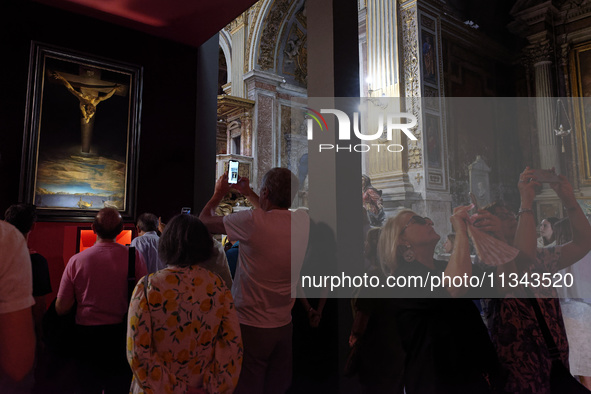 People are taking pictures of ''Dali's Christ'' at San Marcello al Corso Church in Rome, Italy, on June 19, 2024. Salvador Dali's famous pai...