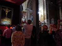 People are taking pictures of ''Dali's Christ'' at San Marcello al Corso Church in Rome, Italy, on June 19, 2024. Salvador Dali's famous pai...