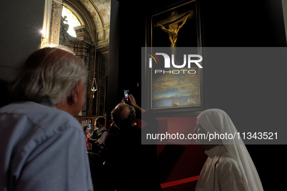 People are taking pictures of ''Dali's Christ'' at San Marcello al Corso Church in Rome, Italy, on June 19, 2024. Salvador Dali's famous pai...