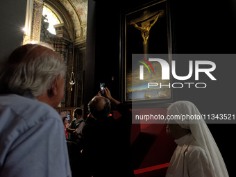 People are taking pictures of ''Dali's Christ'' at San Marcello al Corso Church in Rome, Italy, on June 19, 2024. Salvador Dali's famous pai...