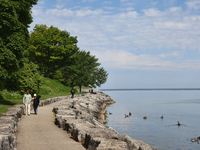 People are walking along a waterfront trail by Lake Ontario at Queen's Royal Park in Niagara-on-the-Lake, Ontario, Canada, on June 12, 2024....