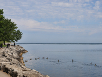 People are walking along a waterfront trail by Lake Ontario at Queen's Royal Park in Niagara-on-the-Lake, Ontario, Canada, on June 12, 2024....