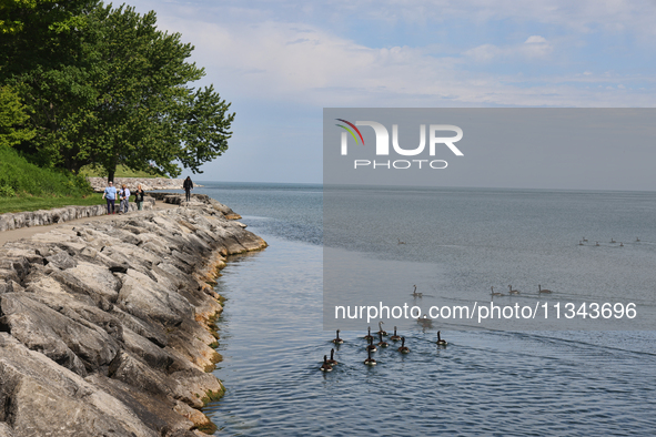 People are walking along a waterfront trail by Lake Ontario at Queen's Royal Park in Niagara-on-the-Lake, Ontario, Canada, on June 12, 2024....