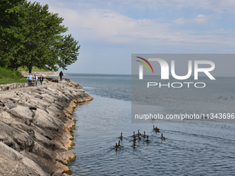 People are walking along a waterfront trail by Lake Ontario at Queen's Royal Park in Niagara-on-the-Lake, Ontario, Canada, on June 12, 2024....