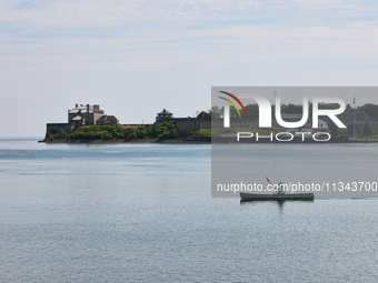 A man is kayaking along Lake Ontario past Old Fort Niagara in New York, USA, seen from Niagara-on-the-Lake, Ontario, Canada, on June 12, 202...