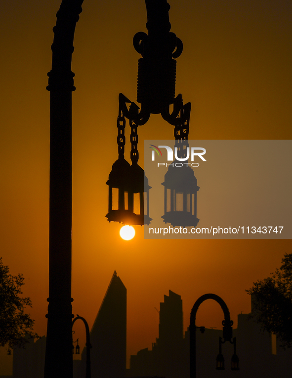 The sunset is illuminating the Doha skyline as seen from Old Doha Port in the warm weather in Doha, Qatar, on June 19, 2024. 