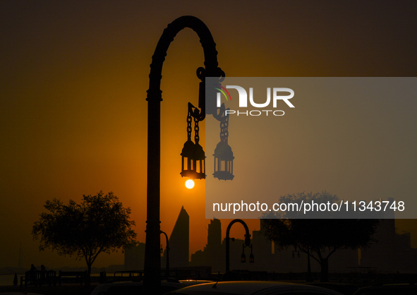 The sunset is illuminating the Doha skyline as seen from Old Doha Port in the warm weather in Doha, Qatar, on June 19, 2024. 