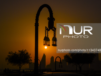 The sunset is illuminating the Doha skyline as seen from Old Doha Port in the warm weather in Doha, Qatar, on June 19, 2024. (