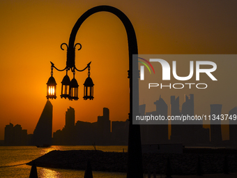 The sunset is illuminating the Doha skyline as seen from Old Doha Port in the warm weather in Doha, Qatar, on June 19, 2024. (