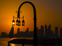 The sunset is illuminating the Doha skyline as seen from Old Doha Port in the warm weather in Doha, Qatar, on June 19, 2024. (