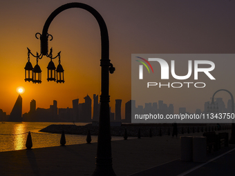 The sunset is illuminating the Doha skyline as seen from Old Doha Port in the warm weather in Doha, Qatar, on June 19, 2024. (