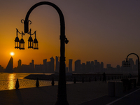 The sunset is illuminating the Doha skyline as seen from Old Doha Port in the warm weather in Doha, Qatar, on June 19, 2024. (