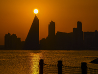 The sunset is illuminating the Doha skyline as seen from Old Doha Port in the warm weather in Doha, Qatar, on June 19, 2024. (