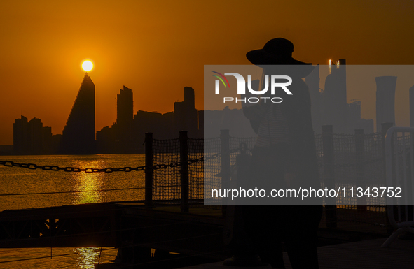 People are enjoying the sunset with the Doha skyline as seen from Old Doha Port in the warm weather in Doha, Qatar, on June 19, 2024. 