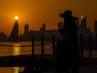 People are enjoying the sunset with the Doha skyline as seen from Old Doha Port in the warm weather in Doha, Qatar, on June 19, 2024. (