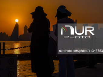 People are enjoying the sunset with the Doha skyline as seen from Old Doha Port in the warm weather in Doha, Qatar, on June 19, 2024. (