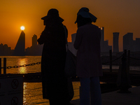 People are enjoying the sunset with the Doha skyline as seen from Old Doha Port in the warm weather in Doha, Qatar, on June 19, 2024. (