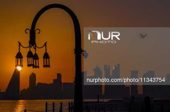 The sunset is illuminating the Doha skyline as seen from Old Doha Port in the warm weather in Doha, Qatar, on June 19, 2024. 