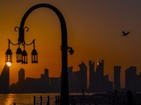 The sunset is illuminating the Doha skyline as seen from Old Doha Port in the warm weather in Doha, Qatar, on June 19, 2024. (